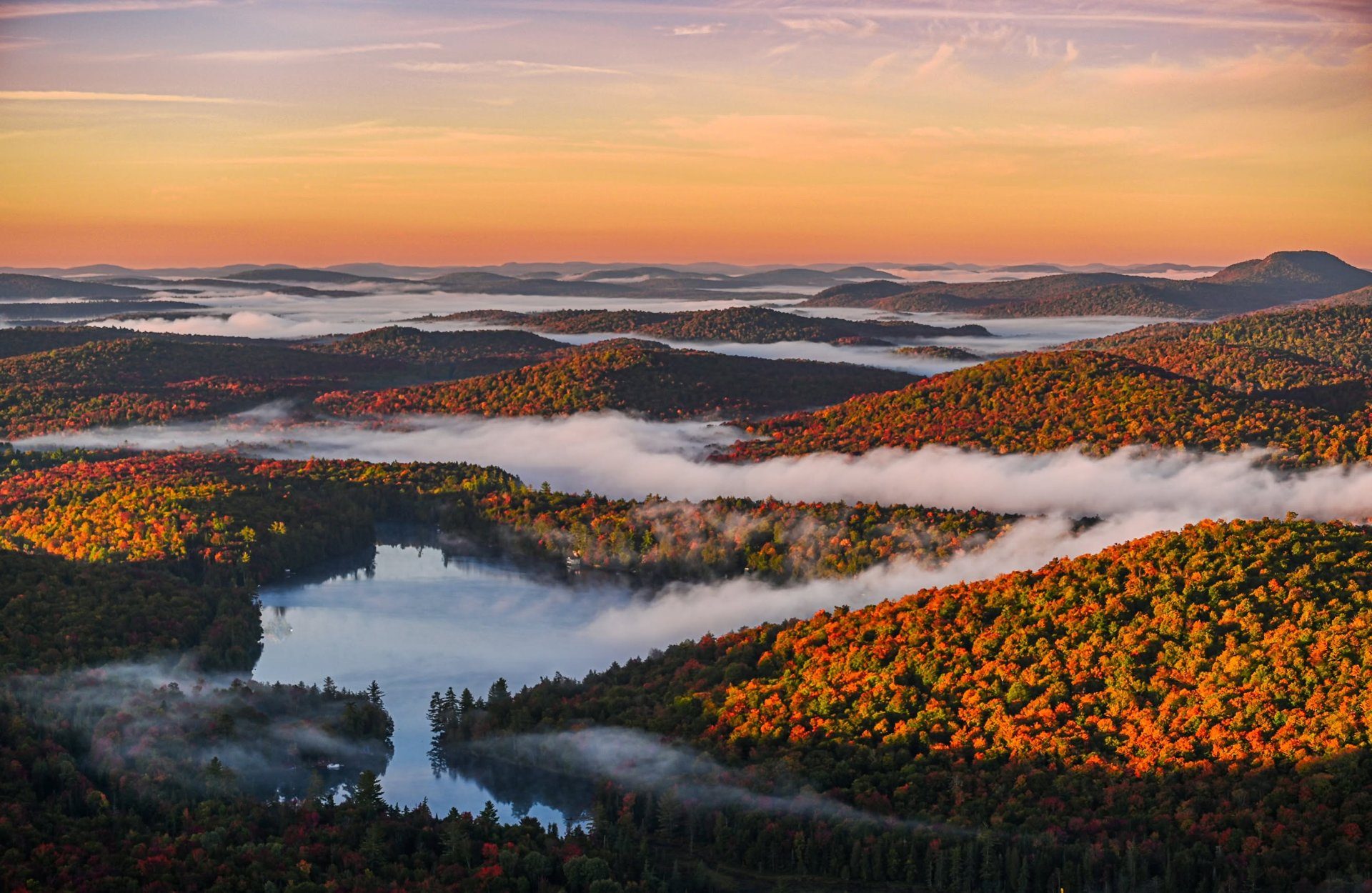 Peak Adirondack fall foliage over a mountain lake